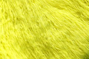 Texture of yellow faux fur as background, closeup