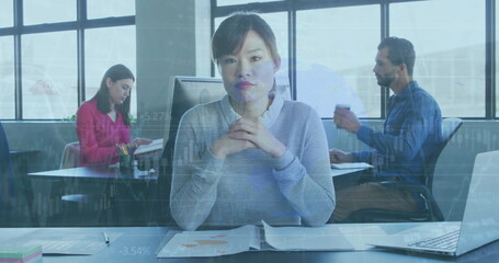 Fototapeta premium Diverse colleagues focusing on work, Asian woman in front