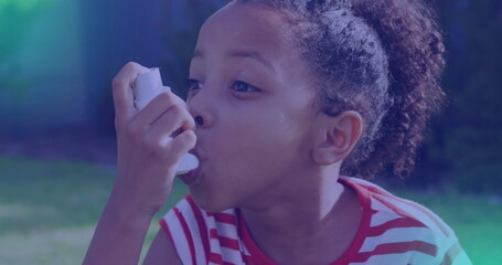 Biracial granddaughter using inhaler, wearing striped shirt