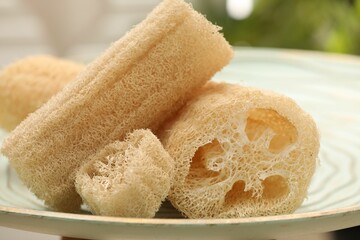 Loofah sponges on table indoors, closeup. Personal hygiene products