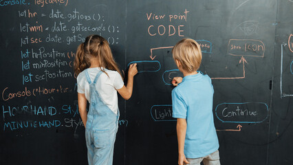 Caucasian girl and smart boy writing blackboard with engineering prompt or coding, programing...