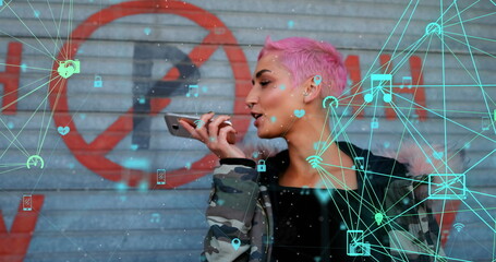 Image of connected icons globes over biracial woman talking on speaker of cellphone