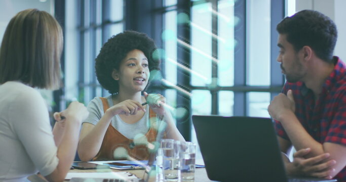 Image of dna strand spinning over diverse business people in office - Powered by Adobe
