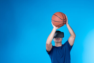 Smart basketball gaming player wearing VR glasses bouncing pose isolated blue background screen...