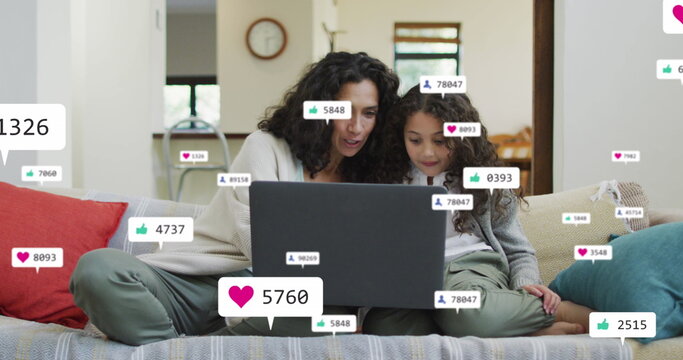 Image of icons with growing numbers over biracial woman and her daughter using laptop