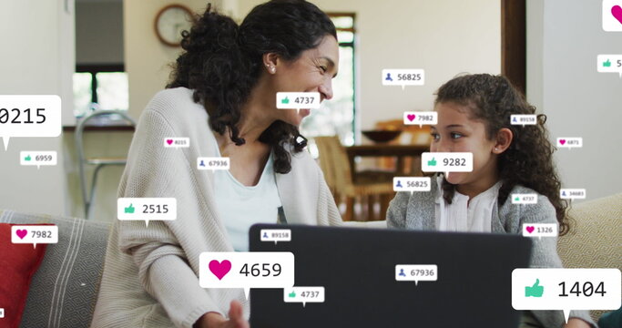 Image of icons with growing number over biracial woman and her daughter using laptop