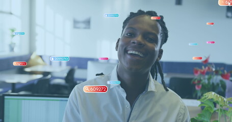 Image of social media icons against portrait of african american man smiling at office