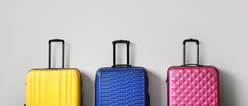 Packed suitcases on light background