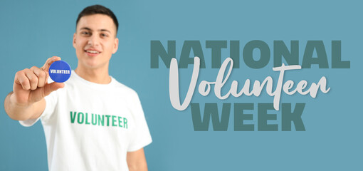 Young male volunteer with badge on color background