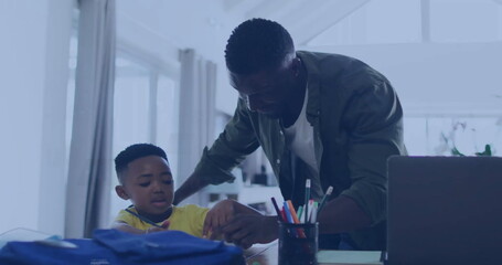 African American father and son drawing together, wearing casual clothes