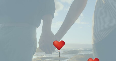 Diverse couple holding hands, one clutching red heart balloon