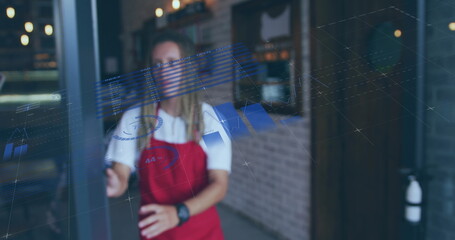 Biracial young professional wearing red apron, cleaning glass door