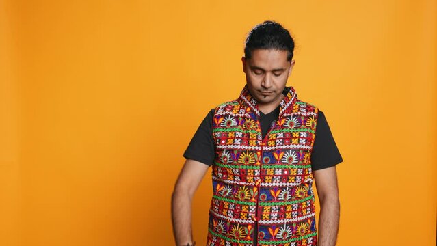 Indian man doing ok hand sign, feeling pleased, agreeing with satisfactory conclusion. Optimistic person doing okay symbol gesturing, offering positive feedback, studio background, camera B