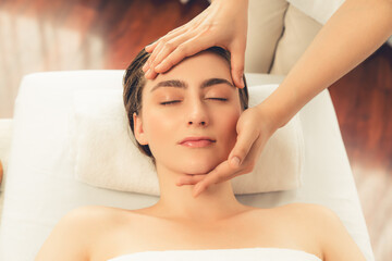 Caucasian woman enjoying relaxing anti-stress head massage and pampering facial beauty skin...