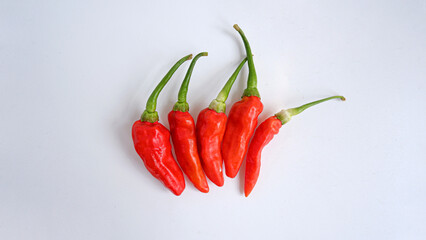 Photo of chilies stacked with white background.