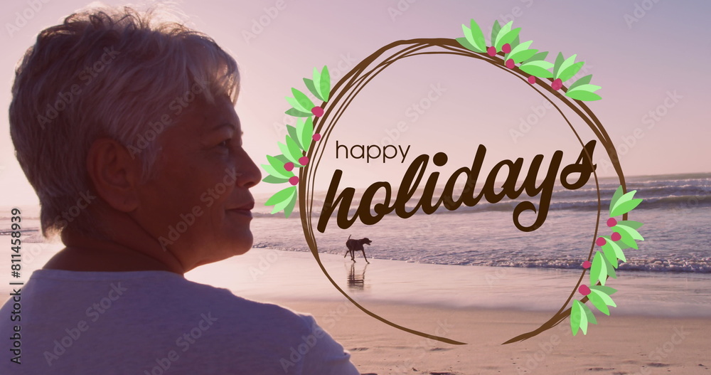 Canvas Prints Image of happy holidays over biracial senior woman on beach