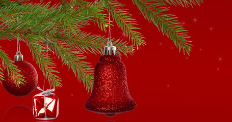 Image of snowflakes over fir tree with bell on red background