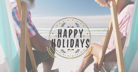 Fototapeta premium Image of happy holidays over happy diverse senior couple on beach
