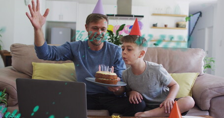 Image of data processing over caucasian father and son at birthday