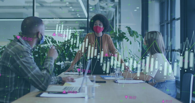 Image of financial data processing over diverse business people wearing face masks at office