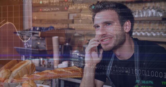 Image of stock market data processing over caucasian male waiter talking on smartphone at cafe