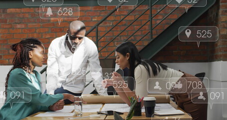 Anmation of social media icons floating over diverse colleagues discussing over a plan at office