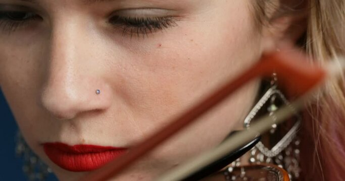 vertical pan closeup on violinist with pink hair strapless
