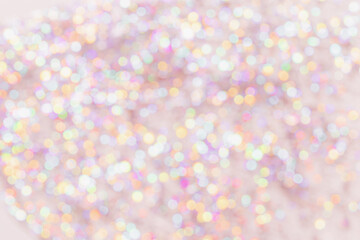 Defocused abstract bokeh background pastel colored, flare from lights, color gradient, blurred circle bokeh as holiday texture. Glittering aesthetic textured lighting pattern