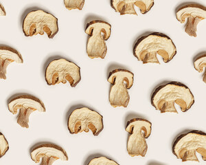 Minimal food pattern beige monochrome colors from dried slices of porcini, dehydrated food boletus mushrooms, top view, aesthetic texture flat lay. Natural forest white mushroom, healthy eating