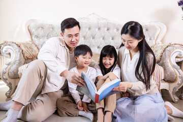 A family of four reading and playing together in the living room