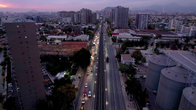 Rodrigo de araya metro station at twilight with busy street traffic, aerial view