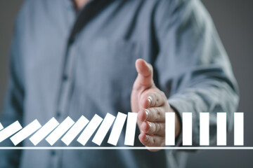 Hand Stopping the digital domino business crisis effect or risk protection concept, business solve...