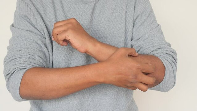 man suffering from itching skin, close up.