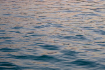 the surface of the sea water is blue. bluish water with calm wave ripples.
