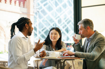 Smiling businesswoman having a cup of coffee with a collegue.