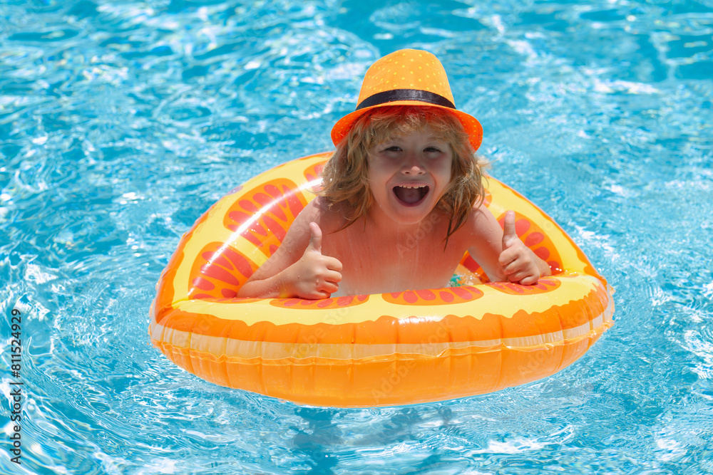 Wall mural kid boy relaxing in pool. child swimming in water pool. summer kids activity, watersports.