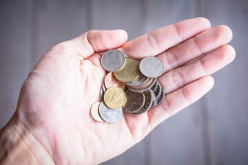 hand with coin baht isolated background