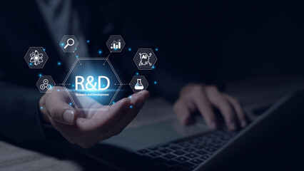 Research and development, businessman uses laptop with R and D icons on virtual screen for research and development, technology, science, business