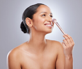 Woman, makeup and brush for beauty application in studio on white background, wellness or...