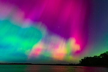 Northern Lights over Lake Burtnieks. Aurora Borealis or Northern Lights Latvia. Aurora reflection in the water at night