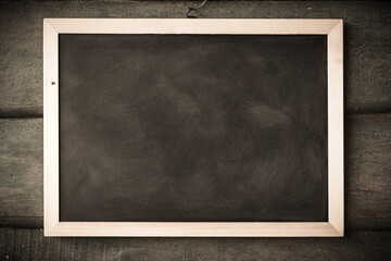 empty Blank chalkboard in wooden frame isolated on wooden background