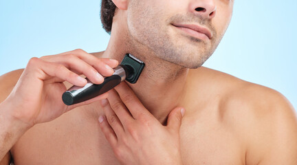 Hands, shaving and man with electric razor on studio backdrop for personal hygiene and skin care....
