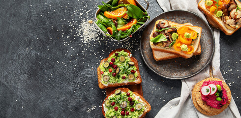 Vegan toast with avocado,mushroom and fresh salad on dark background. Vegetarian food concept