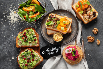 Vegan toast with avocado,mushroom and fresh salad on dark background. Vegetarian food concept