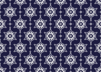 White geometric and symbol flowers design on dark blue background, ethnic fabric seamless pattern design for cloth, carpet, batik, wallpaper, wrapping etc.