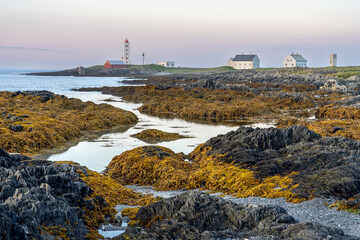 The Kjølnes lighthouse on the vast landscape of the coast of the Barents Sea photographed in the...