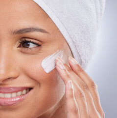 Face cream, skincare and woman in studio with natural, health and fresh facial treatment. Cosmetic,...