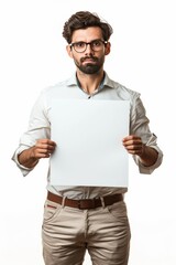 Portrait of a young man holding blank white paper for text isolated on a white background.