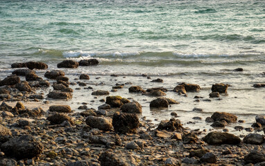 Rocky beach and seas in the background close up