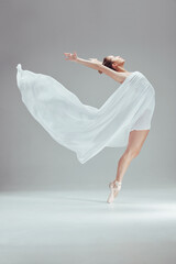 Woman, ballet and fabric with fitness in studio for dancing, balance and performance or art. Female dancer, contemporary and sport by white background for movement, beauty and athlete with grace